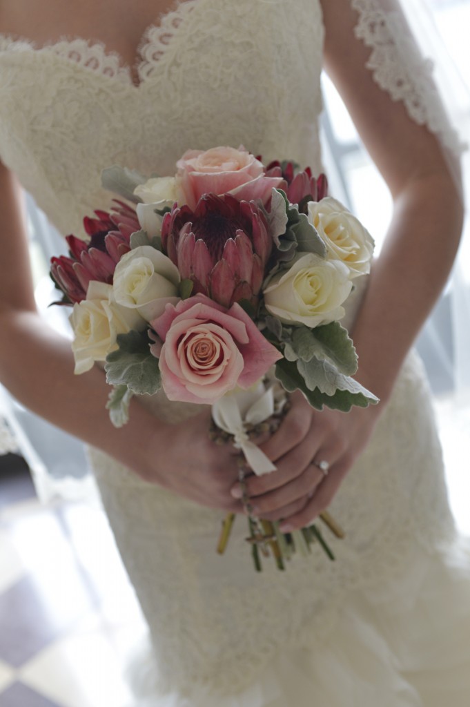 Alison's bouquet featured protea and her grandfather's rosary from the Vatican.  