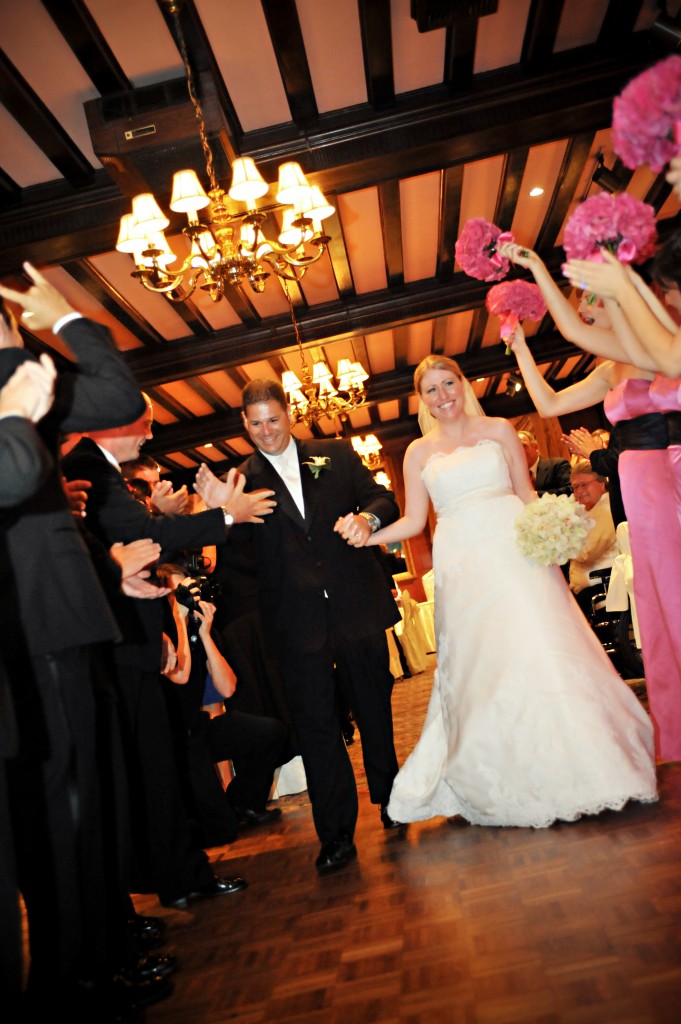 Courtney and Mike are all smiles as they make their entrance into the reception as husband and wife