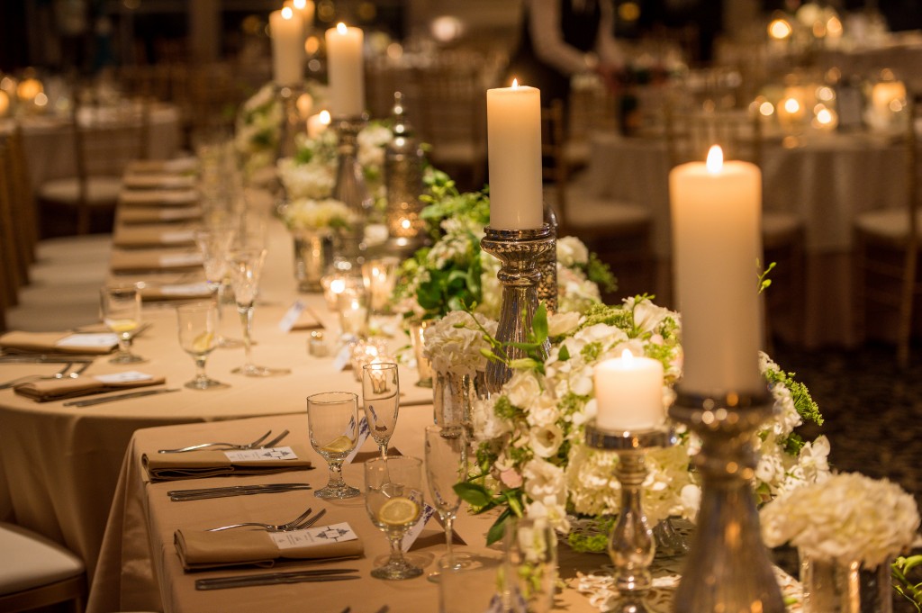 Kristiann and Nick's head table was GORGEOUS.  Mercury glass candle sticks of varying heights interspersed with white floral arrangements on cake stands to give them just enough height.  Photo courtesy of Jeff Tisman Photography.