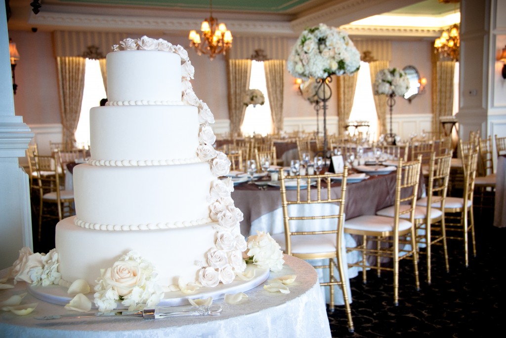 BethAnn and Billy used white, cream and blush pink for an elegant feel to their beach themed wedding.  Photo courtesy of The Artist Group