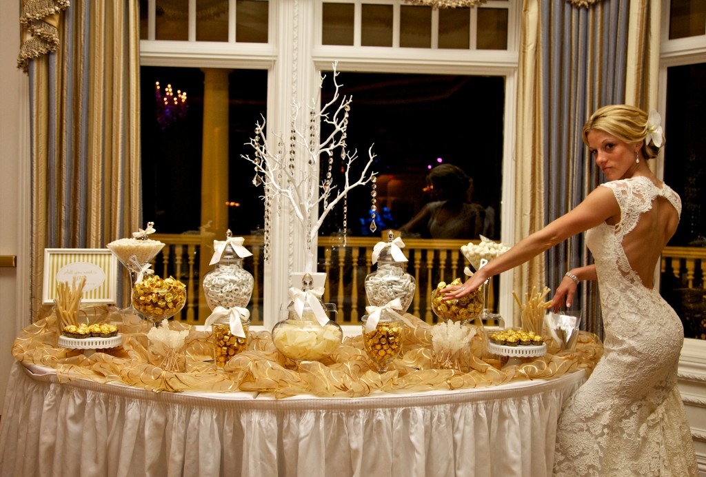 Portia and Greg used gold as their accent color with their white decor which extended all the way to their candy buffet.  Photo courtesy of  Kalen Foley.