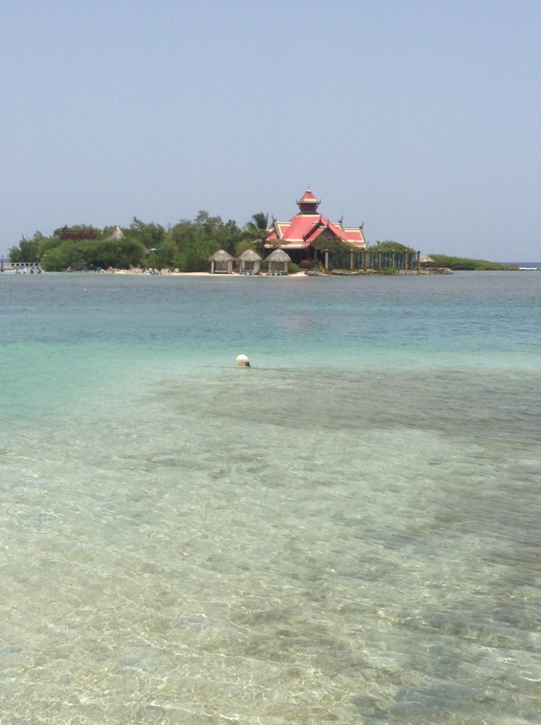 View of Sandals Cay from the dock at Sandals Royal Caribbean resort. Cabanas are shown to the left of the Royal Thai restaurant. The clothing optional beach is on the left side of the island.