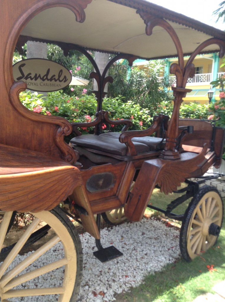 This antique carriage greets guests upon arrival to the entry courtyard. Popular photography spot for WeddingMoon brides and grooms as well as honeymooners at Sandals Royal Caribbean resort.