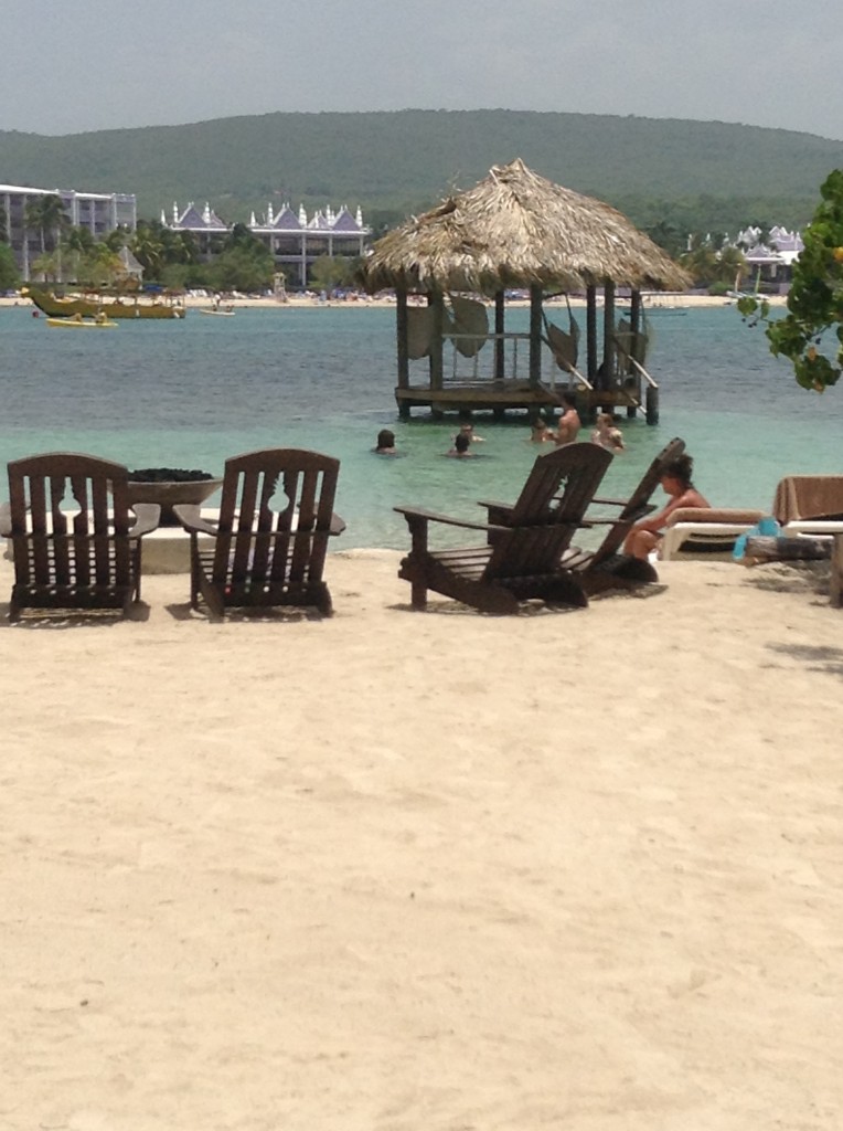 View from Sandals Cay back to Sandals Royal Caribbean Resort. Firepit on the beach. Gazebo in the water with hammocks. If I close my eyes I can see us there.....